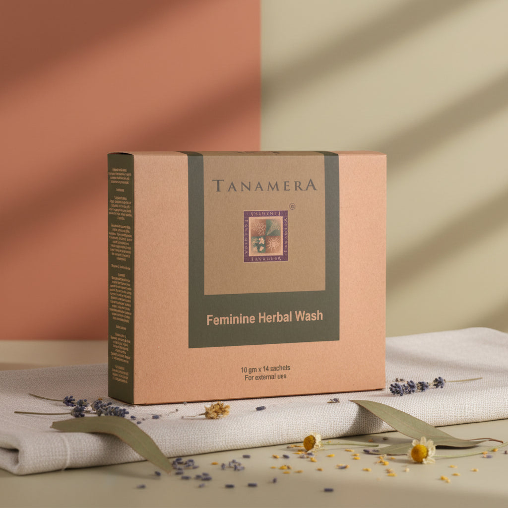 Tanamera Feminine Herbal Wash box in brown kraft paper packaging with a dark olive green central label, shown on a white reflective surface.