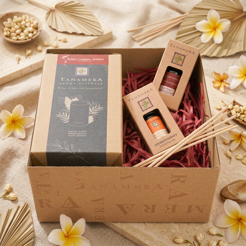 Tanamera aromatherapy gift set in a kraft paper box filled with red paper shred, featuring a large diffuser box, two essential oil bottles, and two smaller boxes.
