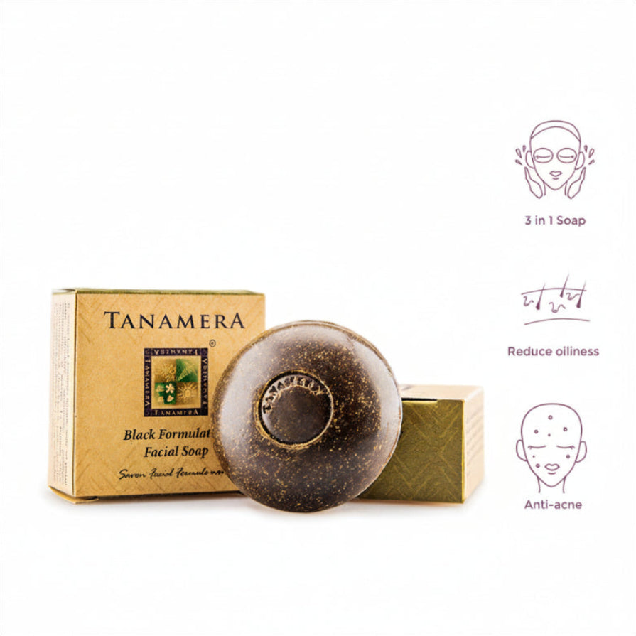 A packaged bar of TANAMERA Black Formulation Facial Soap with its box, which has text and branding, and illustrations indicating the soap's benefits such as 3-in-1, oil control, and anti-acne.