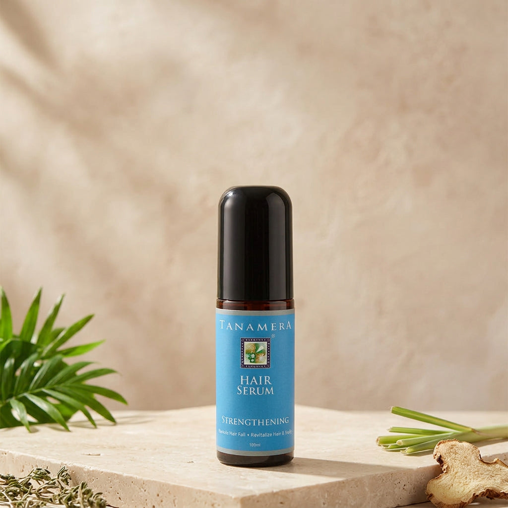 A bottle of Tanamera Hair Strengthening Serum with a blue label, indicating the product is for scalp health improvement and hair strengthening.